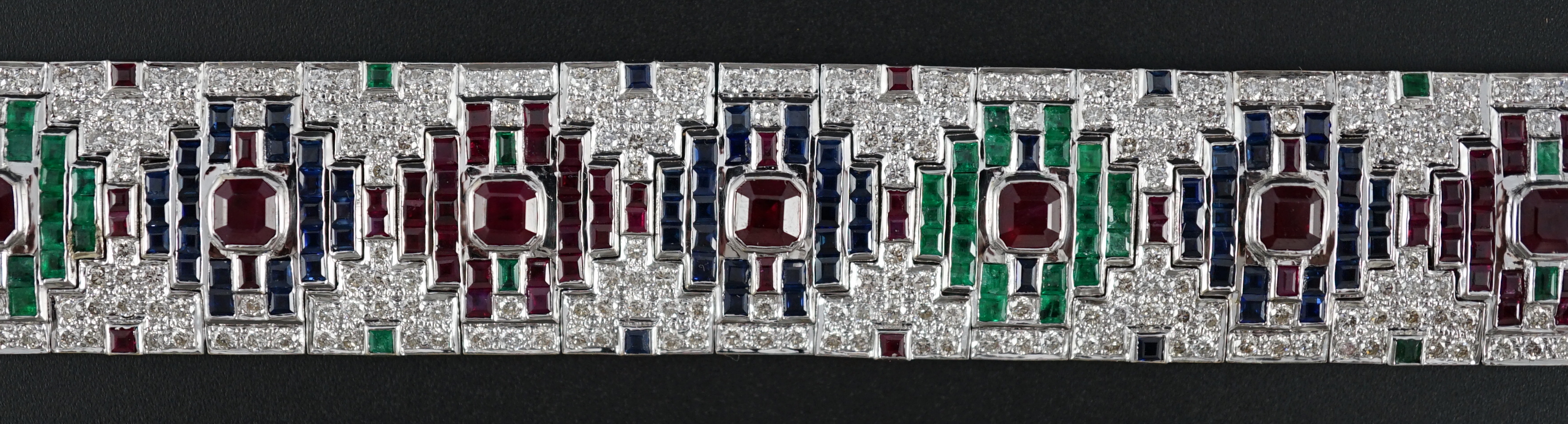 An attractive late 20th century 18k white gold, ruby, sapphire, emerald and diamond set bracelet